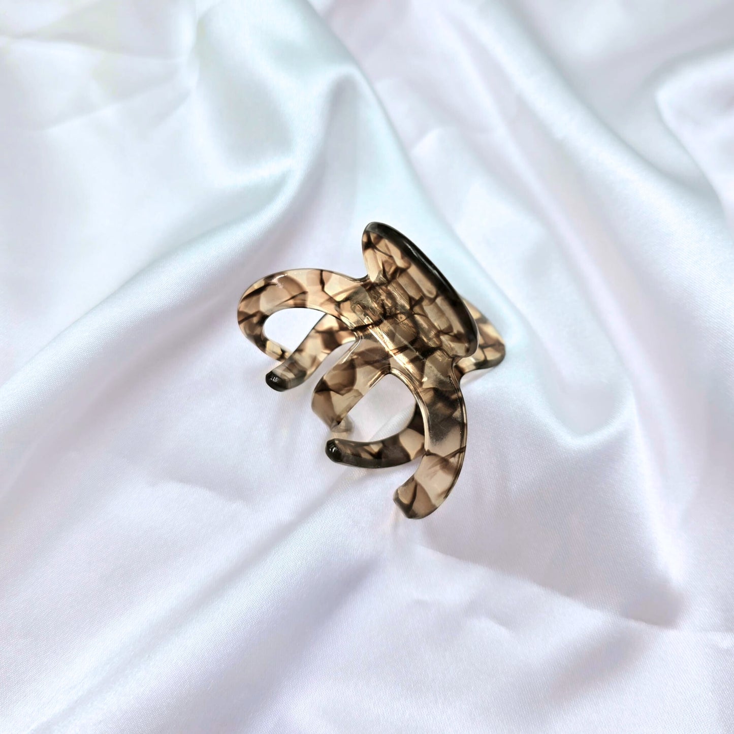 tortoiseshell hair clip on a white satin background